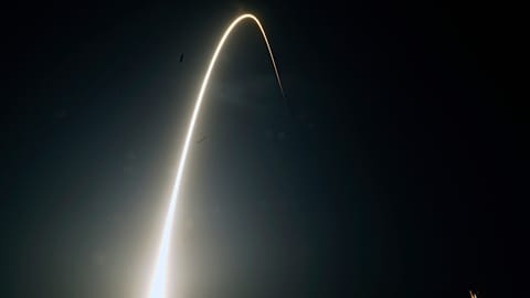 In this time-exposure photograph, a SpaceX Falcon 9 rocket with the 25th batch of approximately 60 satellites for SpaceX's Starlink broadband network lifts off