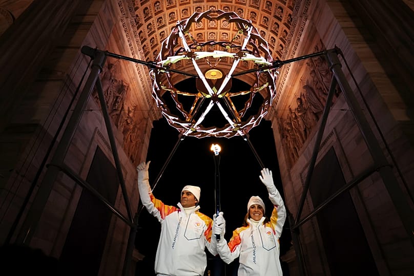 Torchbearers Deborah Compagnoni and Alberto Tomba light the Olympic cauldron, during the Olympic opening ceremony at the 2026 Winter Olympics, in Milan, Italy, Feb. 6, 2026.