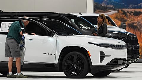 Shoppers look over a 2025 Jeep Wagoneer electric utility vehicle in the Stellantis display at the Colorado Auto Show Thursday, 17 April 2025, in Denver.