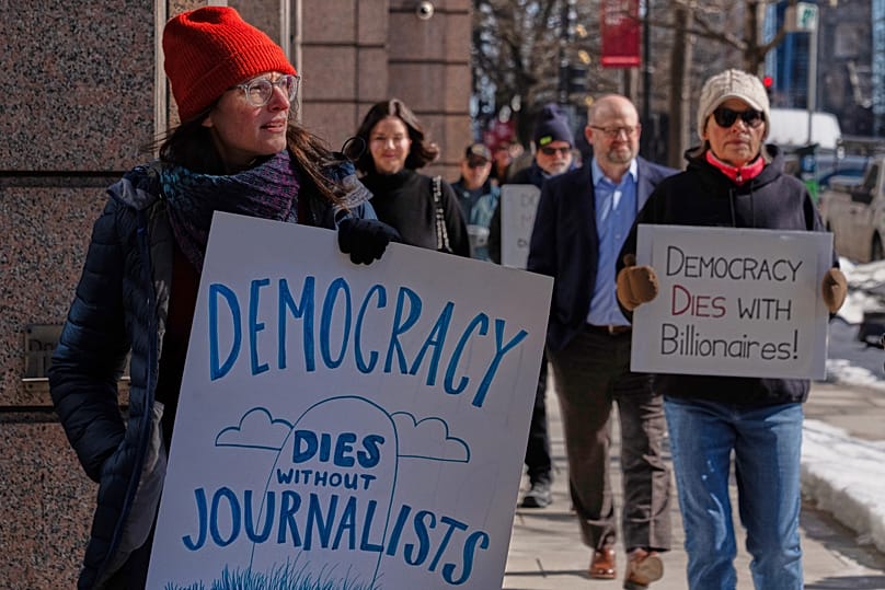 Sarah Kaplan, a Washington Post Journalist, protests outside of the Washington Post office, Thursday, Feb. 5, 2026, in Washington. 