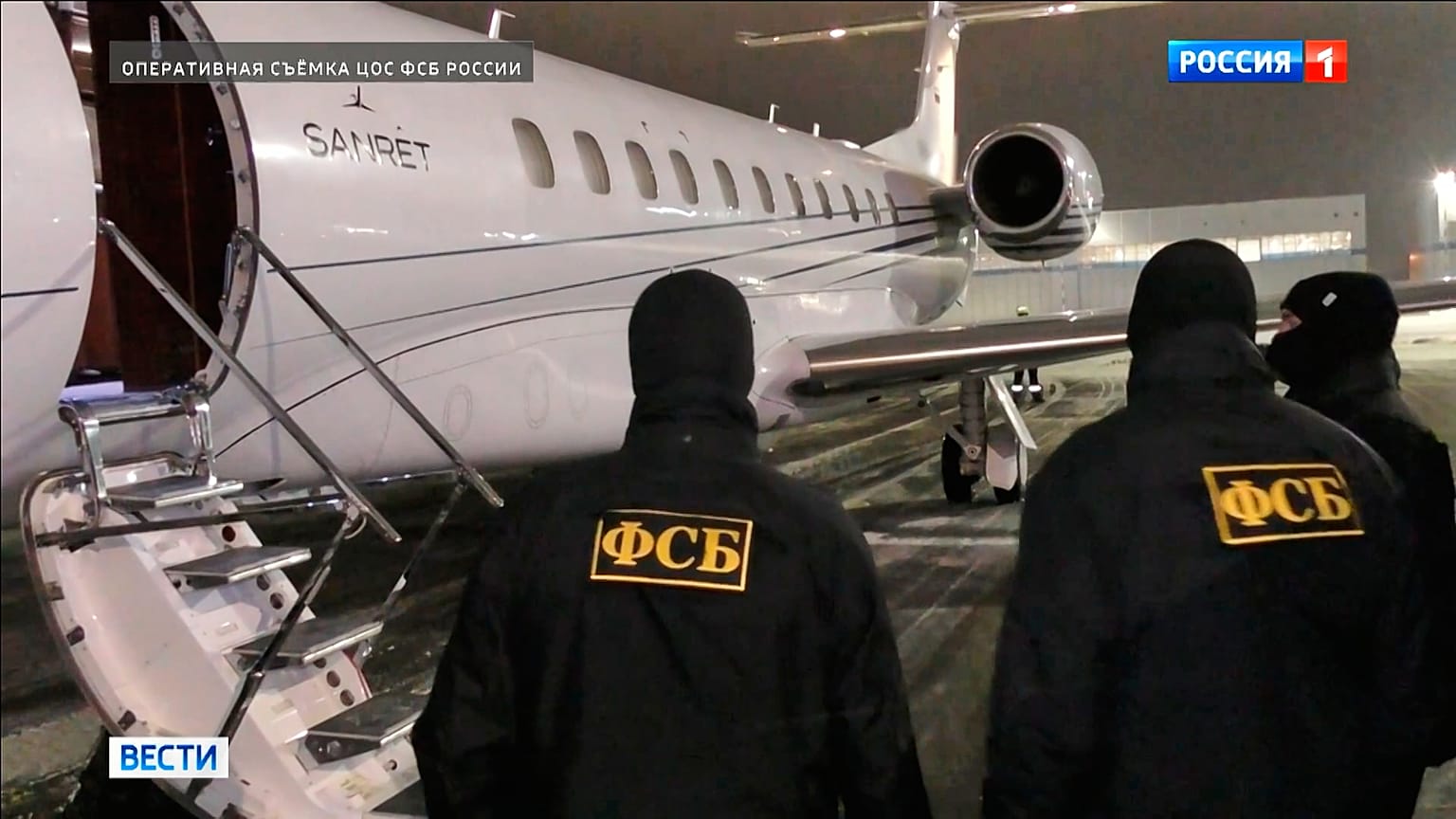 Russian Federal Security Service agents stand at a plane waiting to escort a person suspected in the attempted murder on Lt. Gen. Vladimir Alekseyev, Sunday, Feb. 8, 2026. 