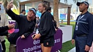 Mirra Andreeva takes a photo with a fan in Doha.