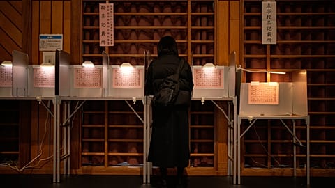 A voter fills in a ballot in the lower house election at a polling station Sunday, 8 February 2026, in Tokyo.