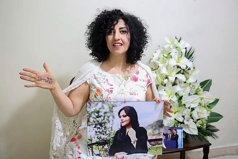 Nobel Peace Prize laureate Narges Mohammad after being released on a medical furlough in Tehran, Iran, 4 Dec, 2024. On her hand written in Farsi is "End gender apartheid."