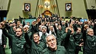 Iranian lawmakers chant slogans as they wear the Revolutionary Guard's uniform in a session of parliament, in Tehran, 1 February 2026