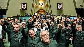 Iranian lawmakers chant slogans as they wear the Revolutionary Guard's uniform in a session of parliament, in Tehran, 1 February 2026