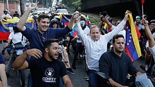 Opposition leader Juan Pablo Guanipa and political activist Jesus Armas ride on the back of motorbikes after their release from prison in Caracas, 8 February 2026
