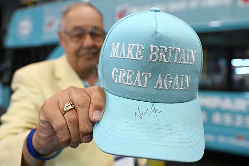 FILE: A member of the party shows his hat signed by Nigel Farage during the Reform party's annual conference at the National Exhibition Centre in Birmingham, 6 September 2025