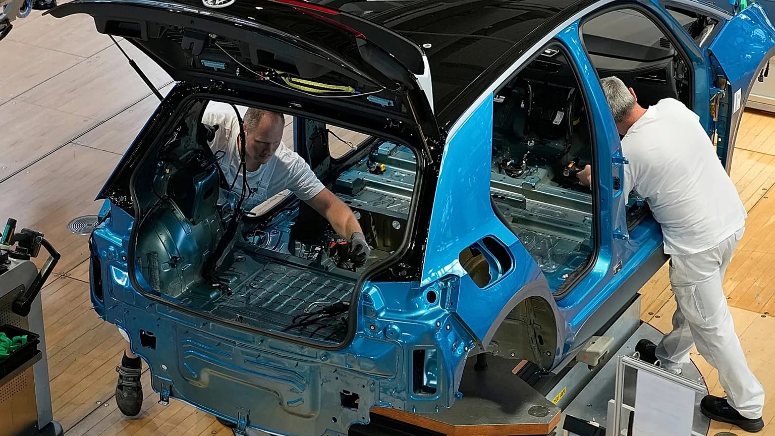 Volkswagen employees assemble an ID.3 electric car at the transparent factory in Dresden, Germany.