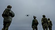 A Ukrainian drone operator from the Kraken 1654 unit, callsign Imla, left, flies a Vampire drone as other soldiers watch, Nov. 5, 2025, in Kharkiv region, Ukraine. 