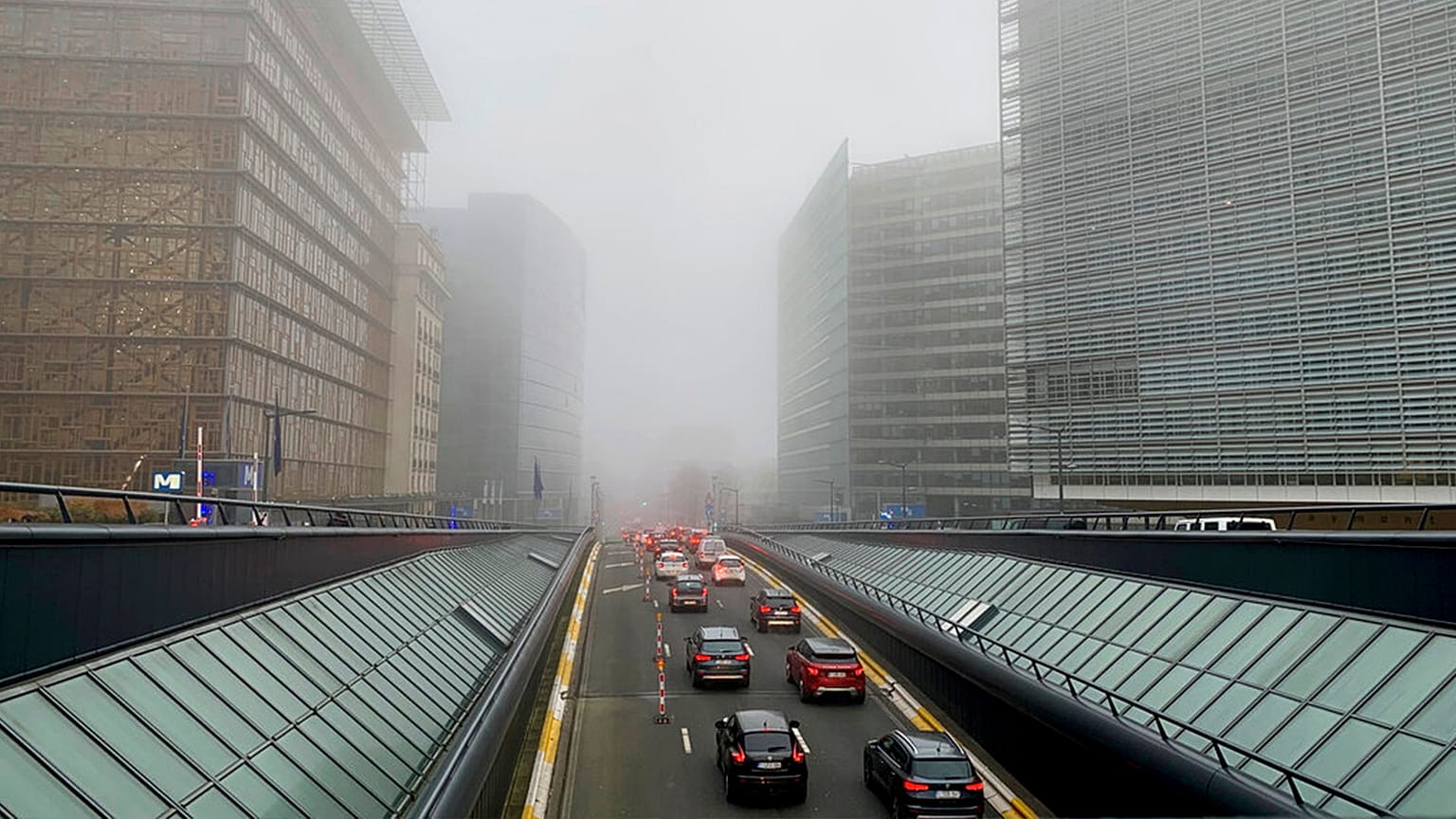 FILE: Cars drive in the fog during morning traffic congestion in Brussels, 25 January 2022