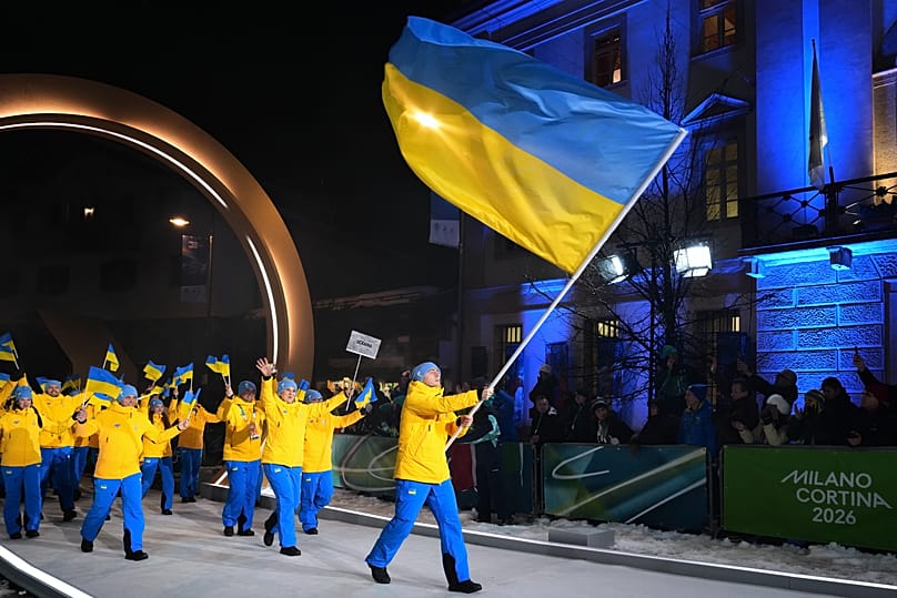 Vladyslav Heraskevych, flag bearer of Ukraine, leads his team in during the Olympic opening ceremony at the 2026 Winter Olympics, in Cortina d'Ampezzo, Italy, Friday, Feb. 6, 