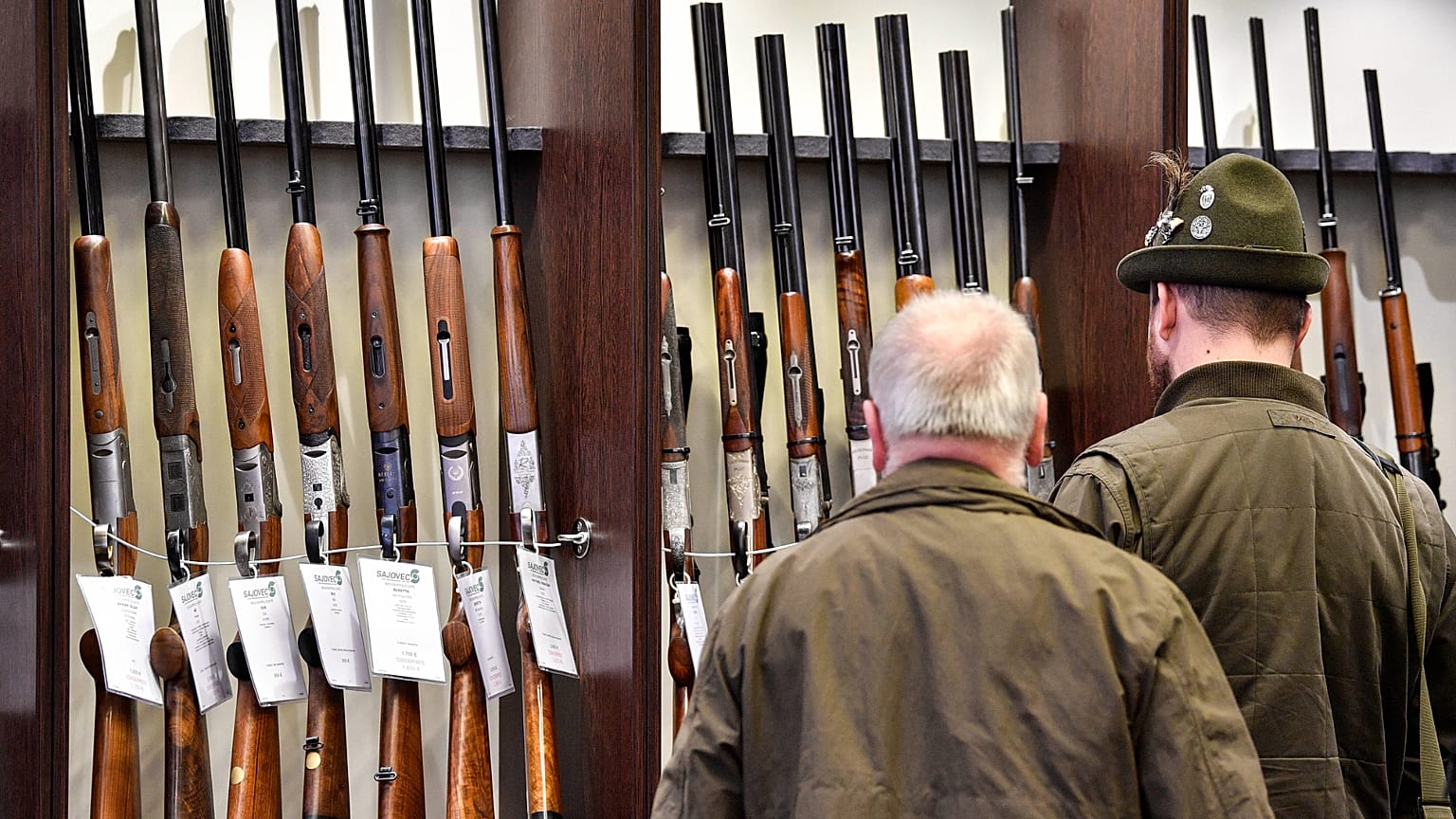 Hunters looking at the latest rifles at the hunting fair in Dortmund, Germany