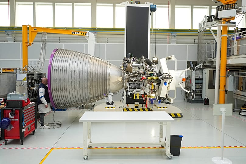 A mechanic looks at the Vulcain 2.1 engine that powers the Ariane 64 rocket, at the ArianeGroup's plant in Vernon, west of Paris, Wednesday, 4 February 2026.