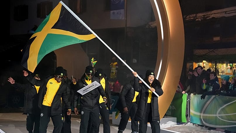 Mica Moore, flag bearer of Jamaica, leads her team in during the Olympic opening ceremony at the 2026 Winter Olympics, in Cortina d'Ampezzo, Italy, Friday, Feb. 6, 2026. 