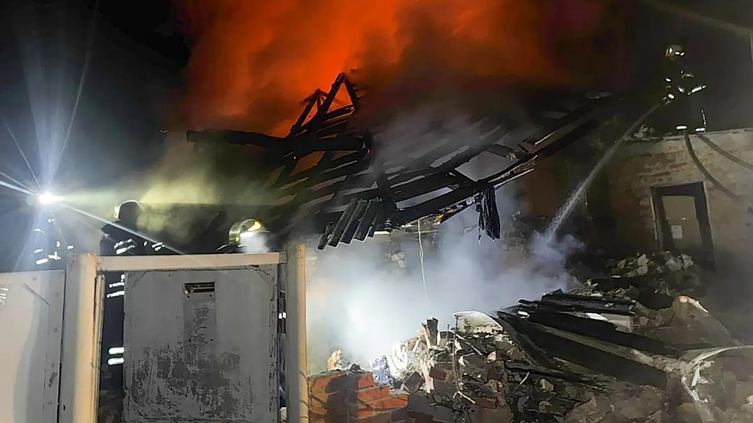 Emergency services personnel work to extinguish a fire at a private house following a Russian air attack in Bohodukhiv, 11 February, 2026