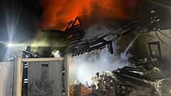 Emergency services personnel work to extinguish a fire at a private house following a Russian air attack in Bohodukhiv, 11 February, 2026