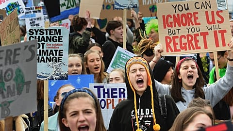 UK students take part in a protest for the climate crisis outside Parliament in London, Friday April 12, 2019.