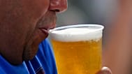 FILE. A spectator drinks beer during the sixth inning of a baseball game between the Texas Rangers and the Toronto Blue Jays Tuesday, 27 May 2025, in Arlington, Texas.