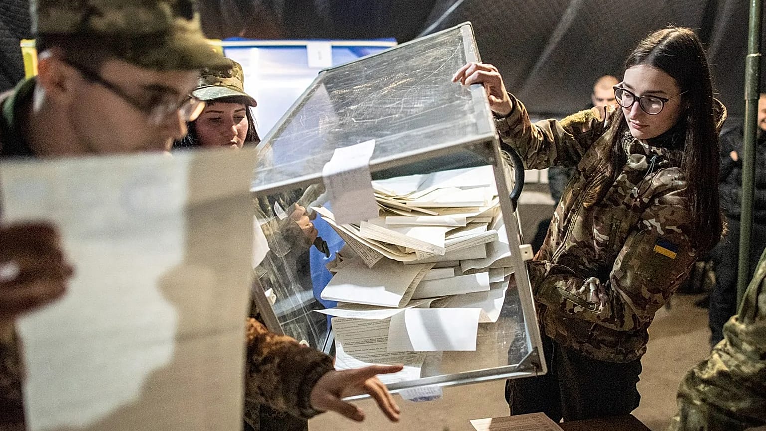 Ukrainian soldiers open a ballot box in a tent using as a polling station during the president elections in Mariinka, 31 March, 2019 