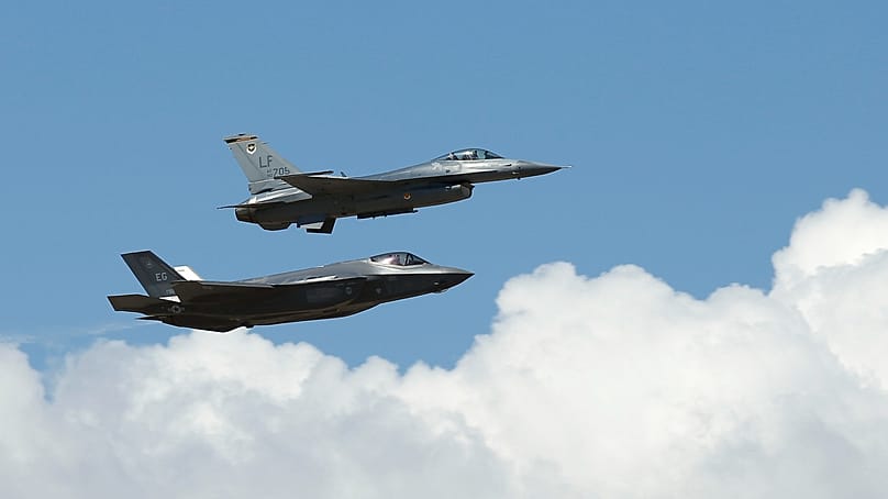 Eine F-35A Lightning II der US-Luftwaffe fliegt neben einer F-16 Fighting Falcon bei einem Überflug auf der Luke Air Force Base in Glendale, Arizona, 14. März 2014