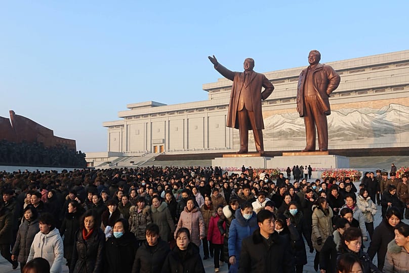 Pyongyang citizens pay respect to the statues of President Kim Il-sung and Chairman Kim Jong-il on Mansu Hill in Pyongyang, 17 December, 2025