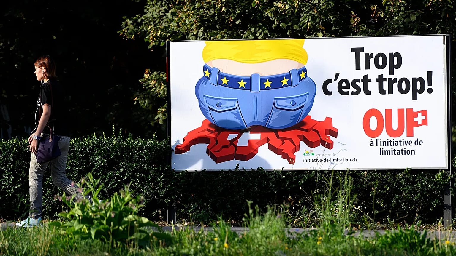 A poster of the Swiss People's Party (SVP) for a moderate immigration initiative reading ''Enough is enough!'' in a street in Lausanne, 27 August, 2020 