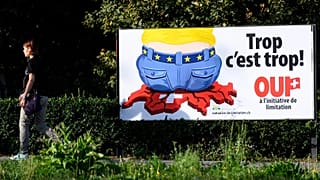 A poster of the Swiss People's Party (SVP) for a moderate immigration initiative reading ''Enough is enough!'' in a street in Lausanne, 27 August, 2020 