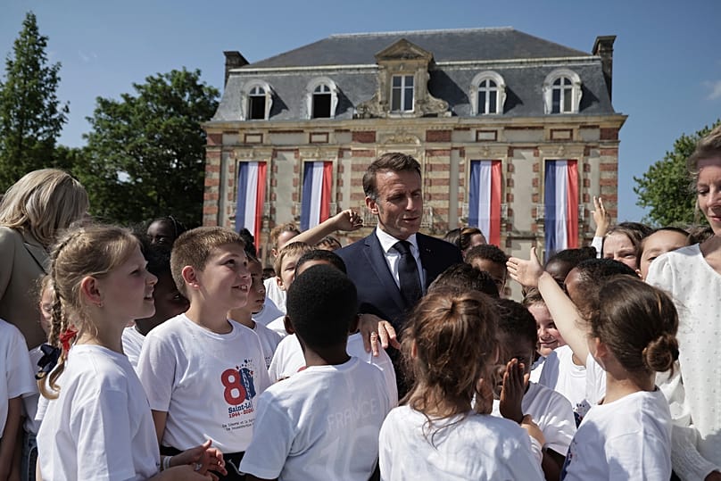 French President Emmanuel Macron meets children ahead of celebrations for the 80th anniversary of D-Day landing in Normandy, 5 June, 2024