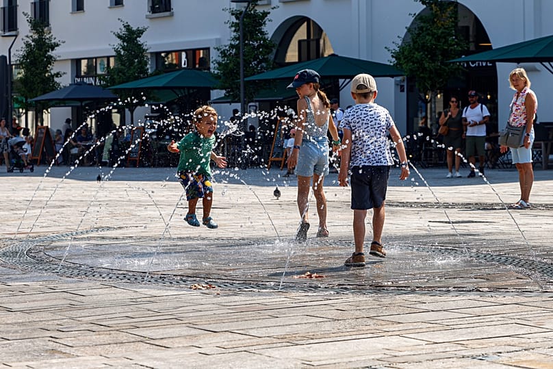 Children play at a water fountain in Saint-Jean-de-Luz, 11 August, 2025