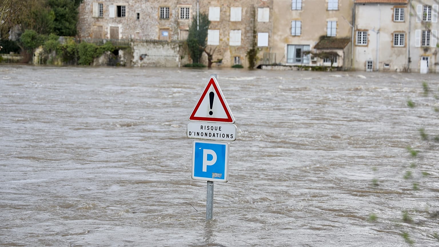 A flooded road with a sign reading "risk of flooding" is seen in Confolens as severe flooding hits western France amid storm Nils, Thursday, Feb. 12, 2026. 