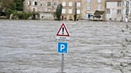 A flooded road with a sign reading "risk of flooding" is seen in Confolens as severe flooding hits western France amid storm Nils, Thursday, Feb. 12, 2026. 