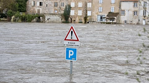 A flooded road with a sign reading "risk of flooding" is seen in Confolens as severe flooding hits western France amid storm Nils, Thursday, Feb. 12, 2026. 