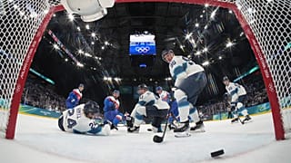 A shot by Slovakia's Adam Ruzicka goes into an open net during a preliminary round match of men's ice hockey at the 2026 Winter Olympics in Milan, 11 February 2026