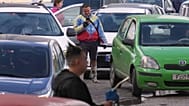 A man wearing a jacket in the colors of Venezuela's flag lines up to purchase fuel at a gas station in Havana, Cuba, Friday, Feb. 6, 2026