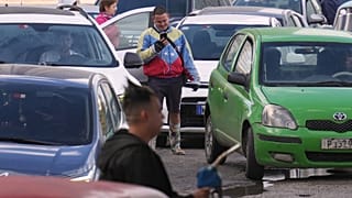A man wearing a jacket in the colors of Venezuela's flag lines up to purchase fuel at a gas station in Havana, Cuba, Friday, Feb. 6, 2026
