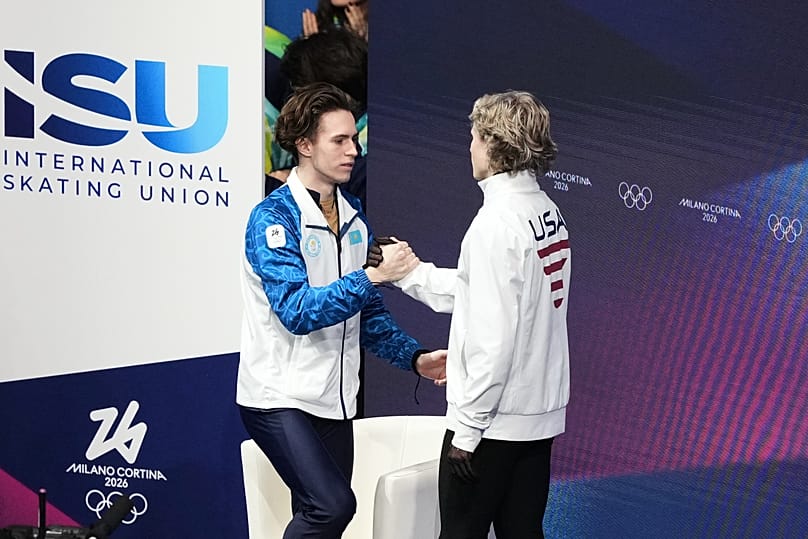 Mikhail Shaidorov and Ilia Malinin following the announcement of the free skate results at the Milano Cortina 2026 Games.