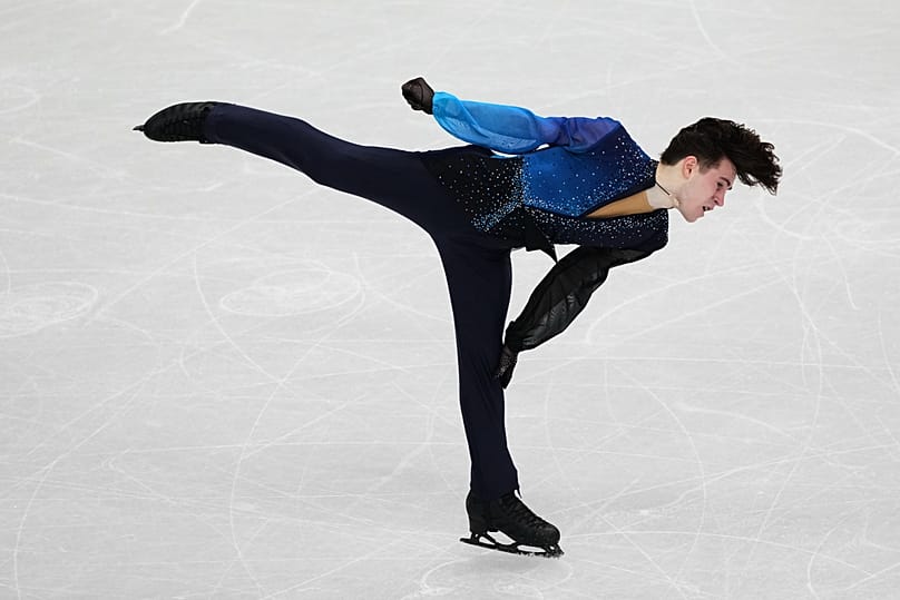 Mikhail Shaidorov captivates the audience during his free program with skillful spins and jumps.