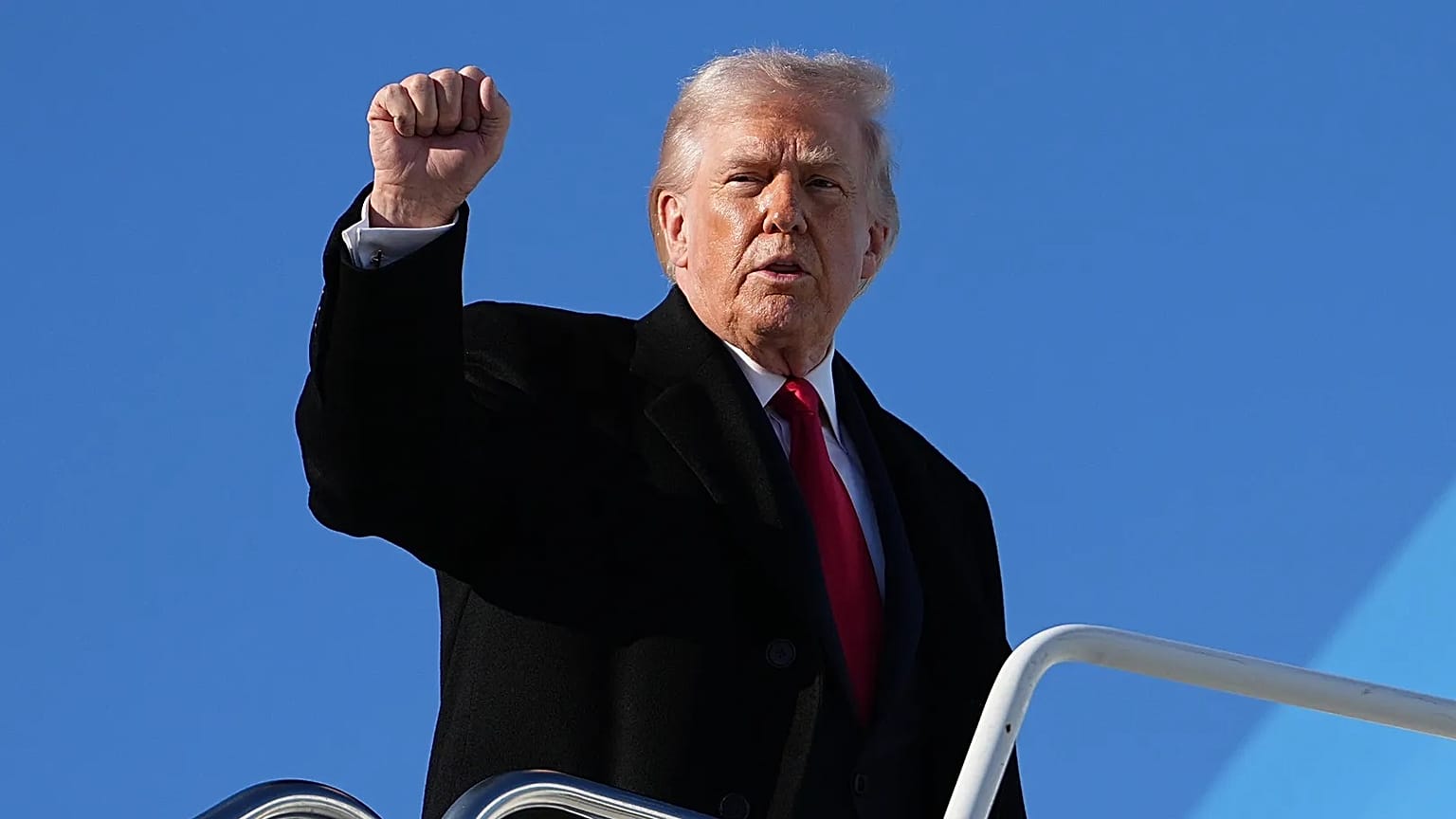 President Donald Trump gestures as he boards Air Force One at Pope Army Airfield, in Fort Bragg, N.C., Friday, Feb. 13, 2026, en route to Palm Beach, Fla. (AP Photo/Matt Rourk