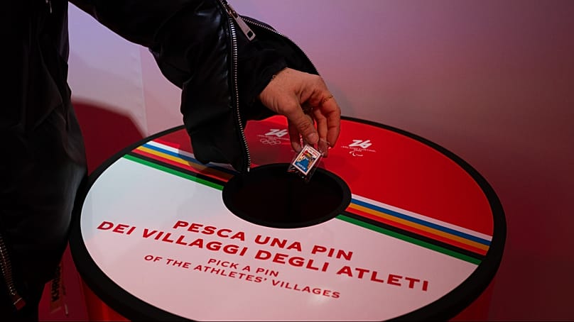 Lucky dip: A visitor to The Peak picks a pin badge from one of the Italian host cities.