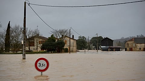A street sign is seen on a flooded road as severe flooding hits western France amid storm Nils in La Reole, Sunday, Feb. 15, 2026.
