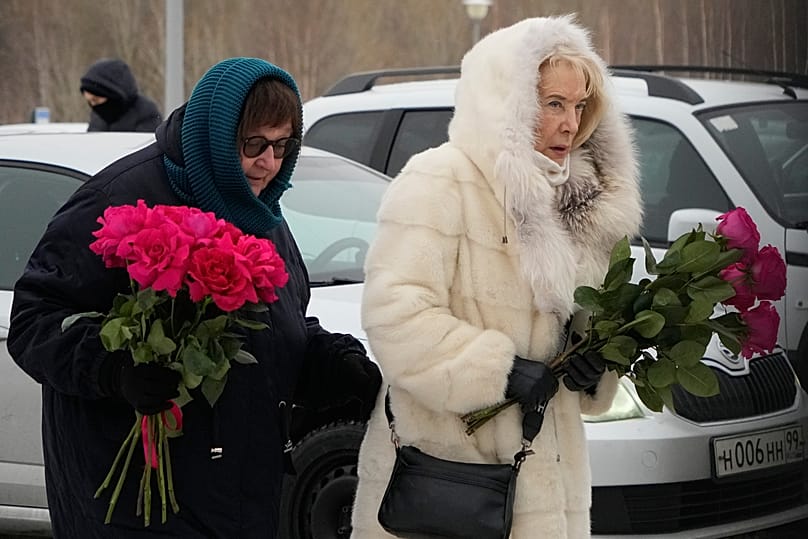 Late Russian opposition leader Alexei Navalny's mother Lyudmila Navalnaya, left, and his mother-in-law Alla Abrosimova, walk to lay flowers at his grave, Monday, Feb. 16, 2026