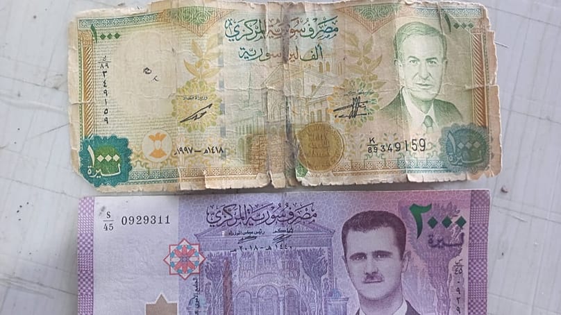 A picture of the Syrian national currency with the image of Hafez al-Assad worth 1000 Syrian pounds and the second with the image of his son Bashar worth 2000 pounds. 