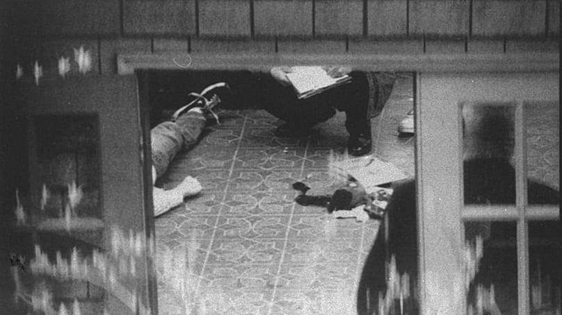 Special investigators examine the body of Kurt Cobain
