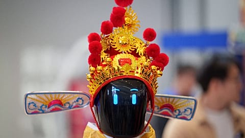 File - A humanoid robot wearing a traditional headdress is displayed during a media preview ahead of Lunar New Year in Beijing, China, February 2026  