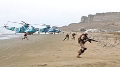 FILE: Iranian navy troops move forward at the coast in an annual drill in the coastal area of the Gulf of Oman and near the strategic Strait of Hormuz, 30 December 2022