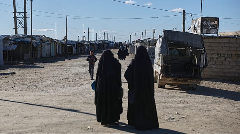 Residents walk along the Al-Hol camp in Al-Hassakeh province, northeastern Syria, Wednesday, Feb. 4, 2026.