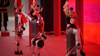 Humanoid robots perform during the media preview of a robotic temple fair celebrated ahead of Lunar New Year, 13 February 2026. 