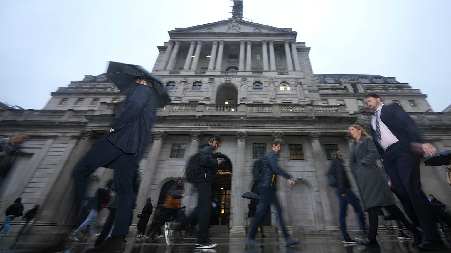FILE - People walk in front of the Bank of England, at the financial district in London, 5 February 2026.