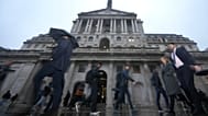 FILE - People walk in front of the Bank of England, at the financial district in London, 5 February 2026.